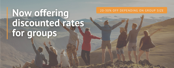 now offering discounted rates for groups with 20-30 percent off depending on group size written above an image of a group of people standing on a mountainside